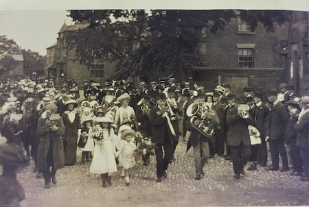 Preocession through Christleton led by a band